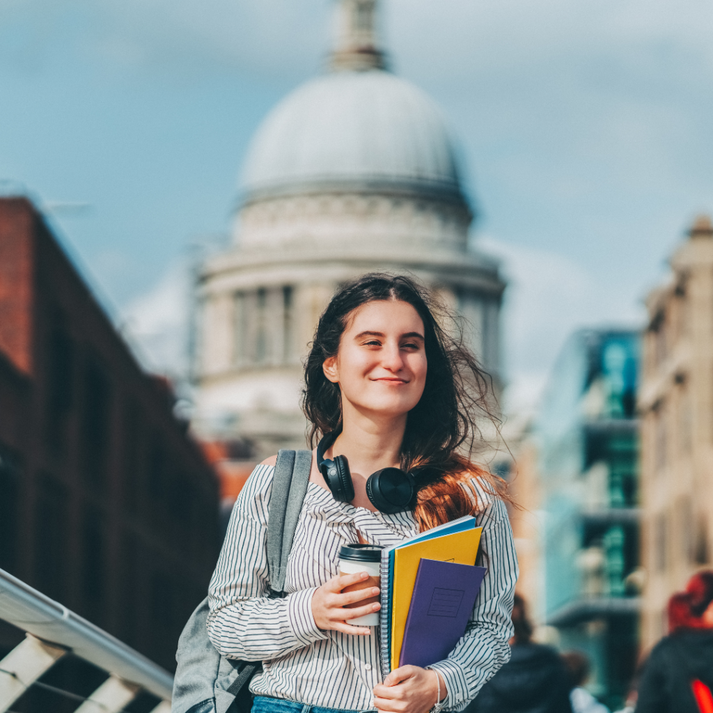 Student with headphones in front of Uk landmark 